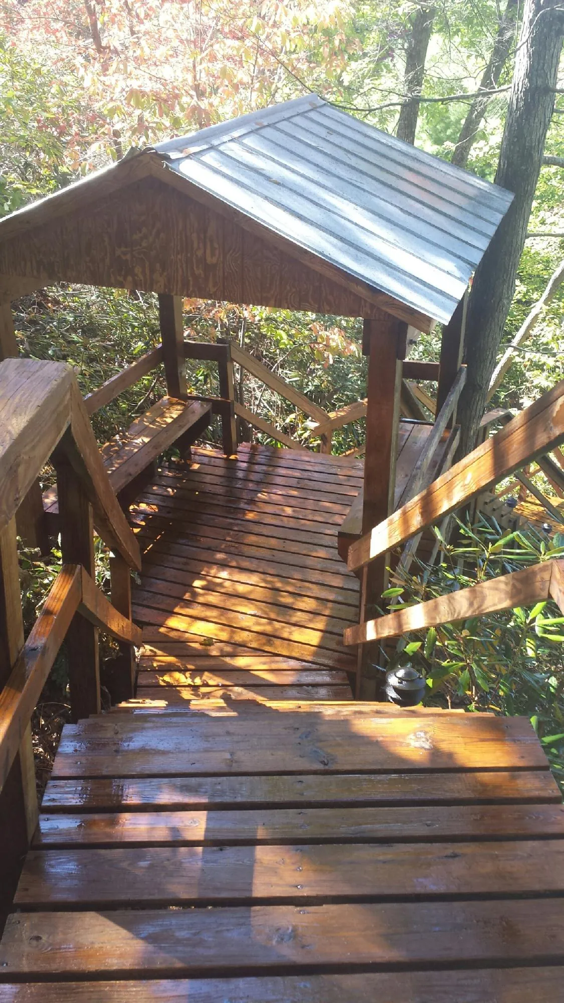 Freshly stained wood walkway and covered shelter with a metal roof in Bessemer